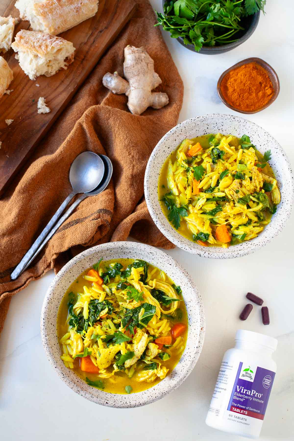 speckled bowl with immmune boosting chicken orzo soup with kale carrots and turmeric